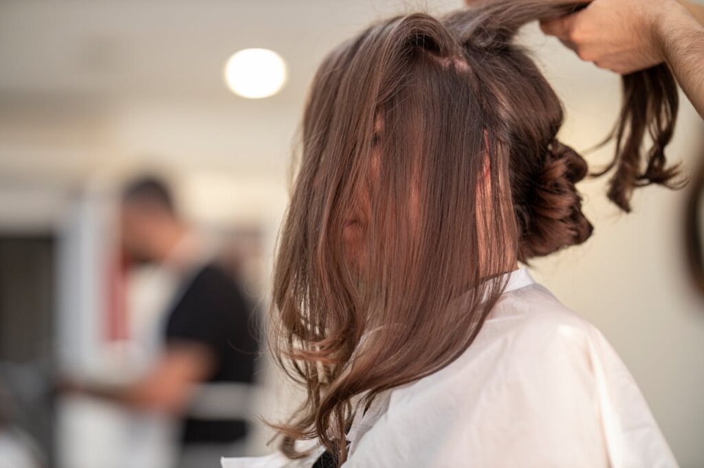 person applying hair color on others hairs